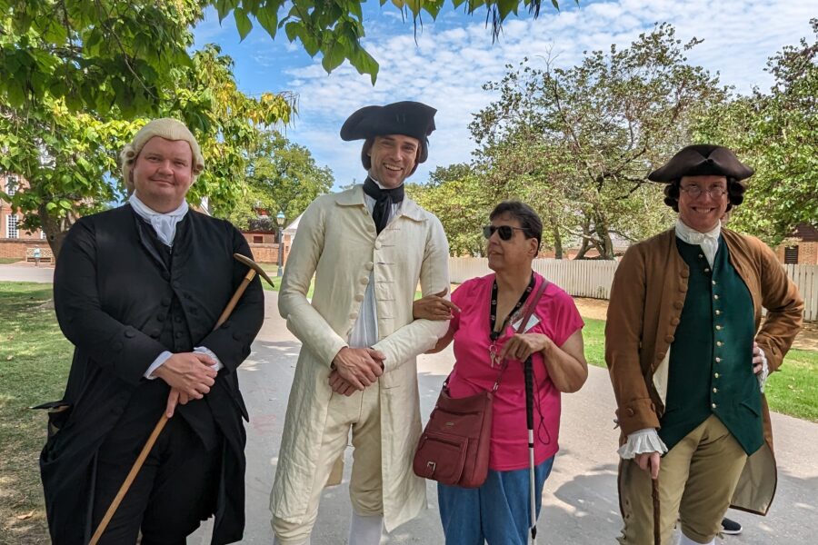 George Washington and other re-enactors at Colonial Williamsburg with a woman visiting.